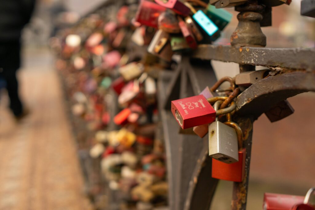 Colorful love locks attached to a bridge railing in Hamburg, symbolizing everlasting love.